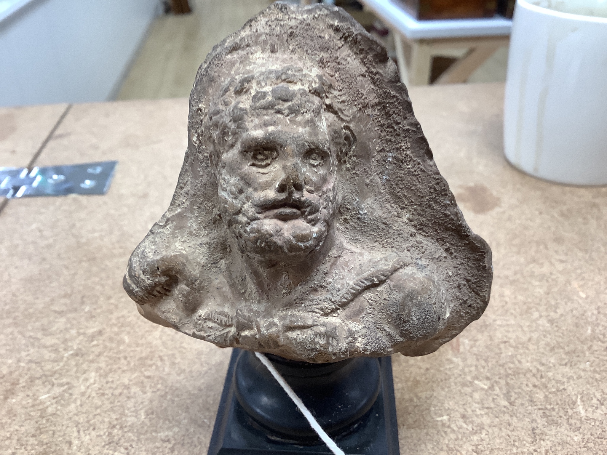 An Etruscan terracotta bearded portrait bust, height 12.5cm